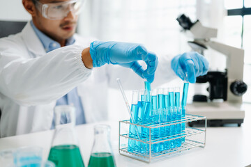 Fototapeta premium Mmale biotechnologist testing new chemical substances in a laboratory...