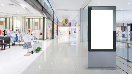 Blank billboard in a modern shopping center. Display for mock-up and advertising. Blackground with...