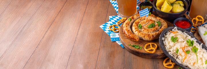  Oktoberfest munich traditional festival menu foods - bavarian sausages, pretzels, potato, sauerkraut, beer bottle and mug,  Background flyer for Oktoberfest invitation on old wooden table