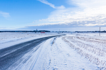 Fototapeta na wymiar Countryside road through winter field