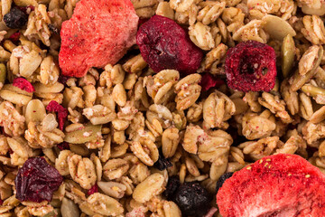 Fototapeta premium Muesli oat cereals close up background with dry fruits