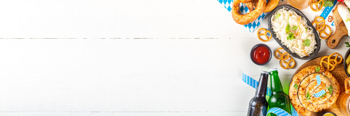  Oktoberfest munich traditional festival menu foods - bavarian sausages, pretzels, potato, sauerkraut, beer bottle and mug,  Background flyer for Oktoberfest invitation on old wooden table