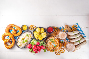  Oktoberfest munich traditional festival menu foods - bavarian sausages, pretzels, potato, sauerkraut, beer bottle and mug,  Background flyer for Oktoberfest invitation on old wooden table