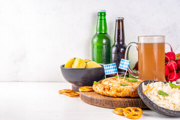  Oktoberfest munich traditional festival menu foods - bavarian sausages, pretzels, potato, sauerkraut, beer bottle and mug,  Background flyer for Oktoberfest invitation on old wooden table