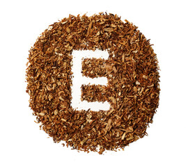 Letter E made of cigarettes dried smoking tobacco on white background
