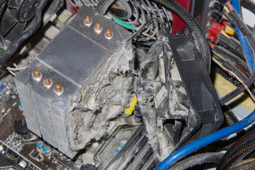 Close-up of a computer cooling system radiator clogged with dust causing the processor to overheat
