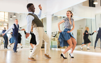 Woman and man dancing swing in studio