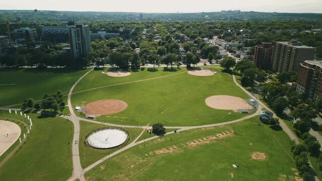 Drone View of four Green Baseball Fields, Baseball Diamond, Sports Field, Public Park in Downtown Halifax, Canada. Empty Baseball Fields and Green Grass in a Sports Park.