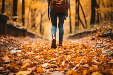 Anonymous woman walking down a leaf covered path created with Generative AI technology