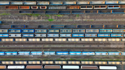 Drone view of freight trains. Colorful railway cargo wagons on railroad. Aerial view of colorful wagons. Depot of freight trains. Railway station. Transportation and Industry.