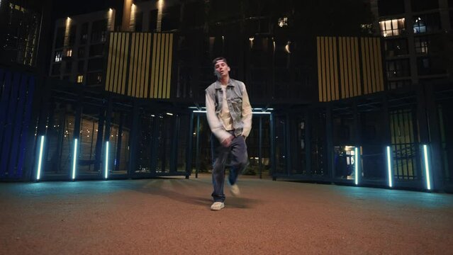 Break-Dancer Dancing Energetically On City Street In Night, Full-Length Portrait, Freestyle Dance