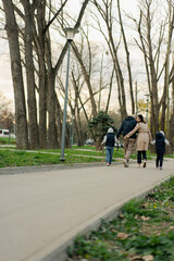 Fototapeta na wymiar Happy family on a walk in the park