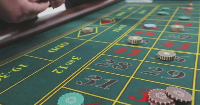 Roulette players make a bet. Casino players make a bet. A roulette player places chips on the game table