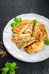 halloumi fried cheese fresh basil meal food snack on the table copy space food background rustic top view