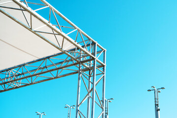 Fragment of an aluminum construction of a hangar or a mobile concert stage with a fabric roof....