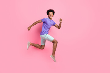 Fototapeta na wymiar Full size photo of pleasant satisfied guy wear t-shirt pants flying running to amazing summer sale isolated on pink color background