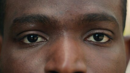 Close up cropped view detail ad male African American ethnic man dark eyes close open blink ophthalmology eyesight see look vision sight eye problem strain sick facial expression looking laser surgery