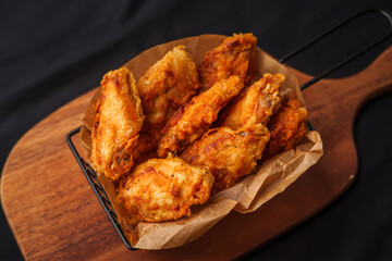 Crispy fried chicken wings on a chopping board