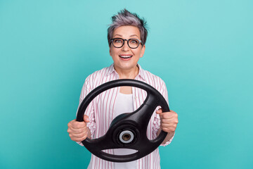 Photo of surprised young woman grey dyed haircut drive steering wheel crazy reaction shock traffic crash isolated on cyan color background