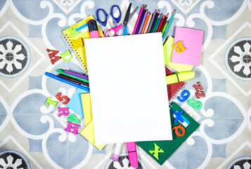 Back to school concept - pencils and notebooks and sticky note and with pins, felt pen on tile background with copy space