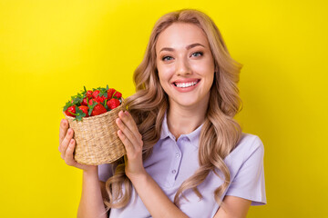 Photo of gorgeous lovely nice girl with curly hairstyle wear violet polo arms holding strawberries...