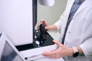 Specialist ophthalmologist in the workplace uses modern equipment