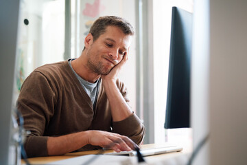 Fototapeta premium Overworked tired employee, programmer at workplace in office being unhappy