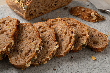 Sliced sourdough loaf of bread with a variation of seeds close up
