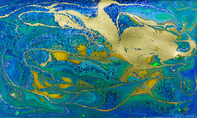 Blue and Gold Glitter on Liquid Blue Ink Background.