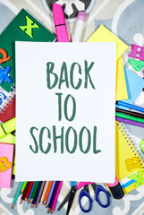 Back to school concept - pencils and notebooks and sticky note and with pins, felt pen on tile background