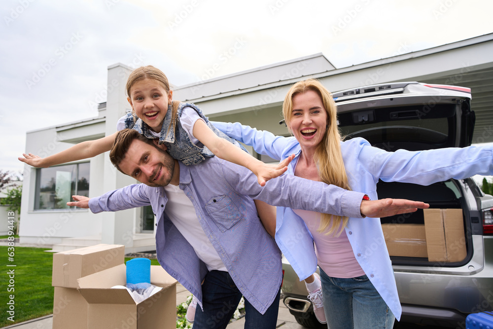 Wall mural Happy family rejoices in moving to a new house