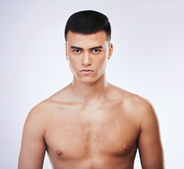 Fototapeta premium Man, beauty and face with skin, cosmetics and grooming, clean and hygiene on white background. Portrait, serious model and dermatology, skincare and treatment with fresh and wellness in studio