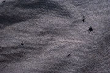 Gray holey fabric, background for work, stitched