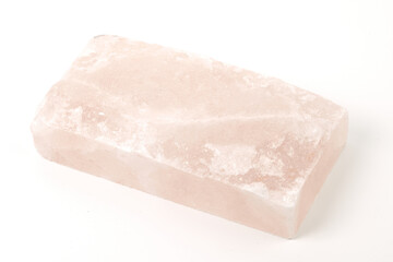 Himalayan salt stone block, crystal of natural pink salt isolated on white background