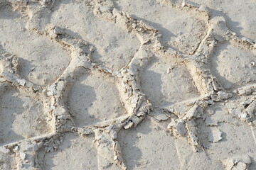 Tracks of heavy machinery in the sand