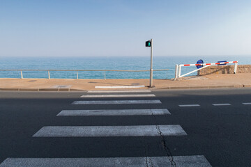 Pedestrian path turns green, inviting a coastal journey.