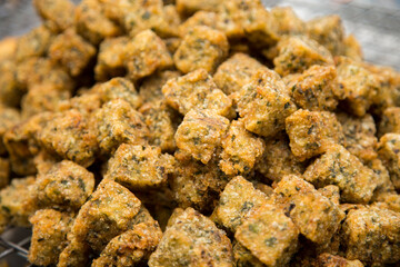 Fried fish starters at a street food stall in the city of Bangkok in Thailand..
