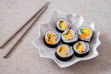 Maki sushi rolls on white plate and chopsticks-Japanese food