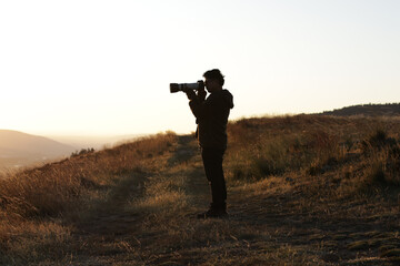 Photograph silhouette of photographer in a sunset in the mountains of Peru. Concept of lifestyles, professions and nature.