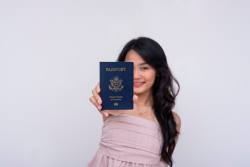 A happy and excited asian woman showing off acquired American passport. Focus on passport. Isolated on a white background.