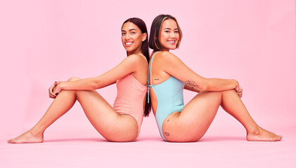 Diversity, swimwear and women in studio portrait, sitting together with smile and fun body...