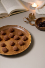 Chocolate truffles covered with cocoa powder. Gray background. Delicious dessert concept.