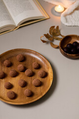 Chocolate truffles covered with cocoa powder. Gray background. Delicious dessert concept.