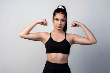 Fototapeta na wymiar young latin woman wearing sportswear doing figure poses and gestures happy on white background