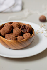 Chocolate truffles covered with cocoa powder. Gray background. Delicious dessert concept.