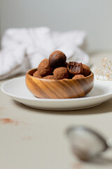 Chocolate truffles covered with cocoa powder. Gray background. Delicious dessert concept.