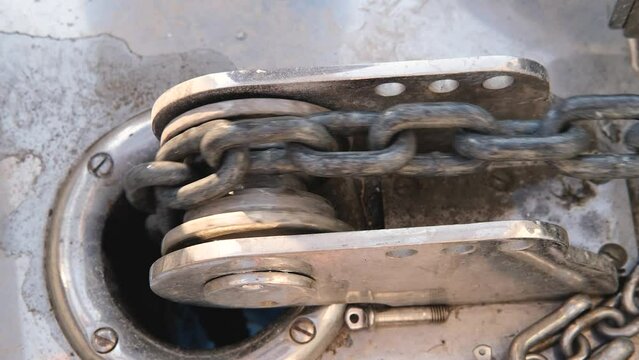 working vessel anchor windlass with chain movement, rusty texture, motor yacht hydraulic equipment, horizontal video