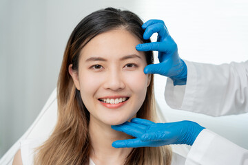 Cosmetic surgery, beauty, Surgeon or beautician touching woman face, surgical procedure that...