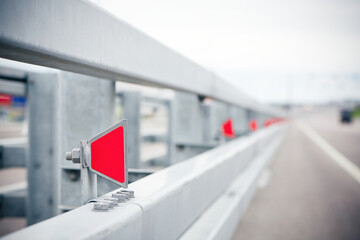 Road metal bump with red reflectors. Road elements for safety traffic.