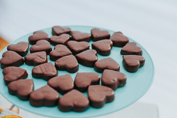 Photo of a fountain of chocolates in the shape of a heart. Concept of desserts and food.